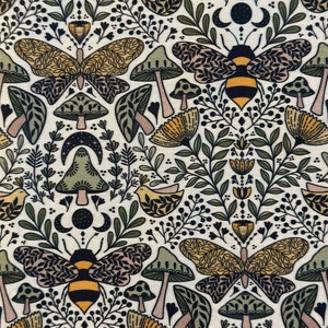 May include: A white fabric with a repeating pattern of green leaves, yellow flowers, mushrooms, butterflies, and bees. The pattern is in a folk art style.