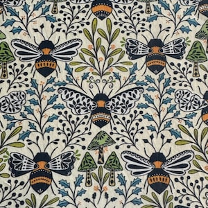 May include: Cream-colored fabric with a repeating pattern of bees, mushrooms, and foliage. The bees have orange and black bodies with detailed wings. Green and blue leaves and mushrooms are interspersed throughout the design.
