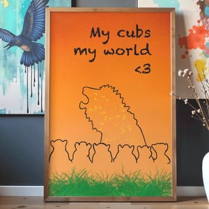May include: Framed art print with an orange and yellow gradient background. The artwork features a lion silhouette with the text "My cubs my world <3". Below the lion are several cub silhouettes and green grass.