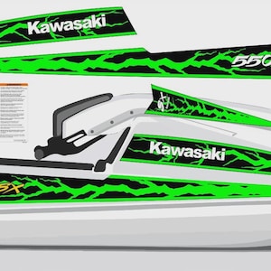May include: A white Kawasaki 550SX jet ski decal kit featuring black and neon green lightning bolt patterns. The set includes side hull graphics with the Kawasaki logo and 550SX text, along with two rectangular warning labels with printed text.
