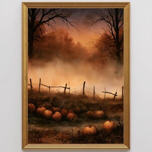 May include: A framed wall art print depicting a pumpkin patch at dusk. The scene features orange pumpkins scattered across a field, a weathered wooden fence, and dark silhouettes of bare trees against a hazy, golden-orange sunset sky.