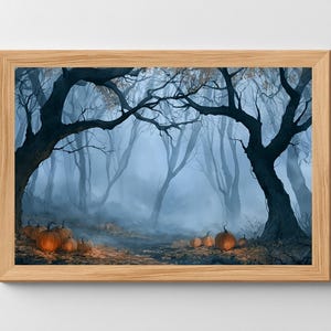May include: A framed landscape art print depicting a misty, dark forest scene with bare, gnarled trees and a collection of orange pumpkins scattered across the ground among fallen leaves, all enclosed within a light-toned wooden frame.