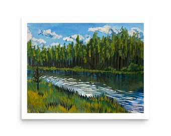 May include: Watercolour painting of a river scene with a forest in the background. The water reflects the sky and trees. Green grass and a small tree are in the foreground. The sky is blue with white clouds.