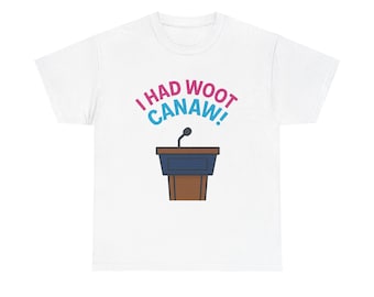 May include: White t-shirt with the phrase "I had woot canaw!" in pink and blue, above a cartoon podium with a microphone. The podium is brown and blue.