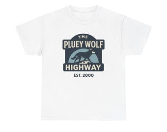 May include: White t-shirt featuring a navy blue and light blue graphic. The graphic includes the text "THE PLUEY WOLF HIGHWAY EST. 2000" with an illustration of a wolf. The shirt is made of a soft material.