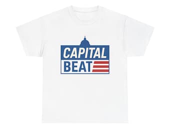 May include: White t-shirt with a blue and red graphic. The graphic features the text "CAPITAL BEAT" in blue, with a capitol building silhouette above and red stripes below, resembling a flag.