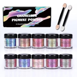 May include: A set of 10 chameleon pigment powder jars with black lids, each containing 3 grams of powder. The set includes a black box labeled "CHAMELEON PIGMENT POWDER" and two double-ended sponge applicators. The jars display various color-shifting hues.