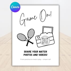 May include: A white poster with black line art featuring tennis rackets, a camera, and the words "Game On!" and "Share Your Match Photos and Videos!". A QR code is in the center of the camera.