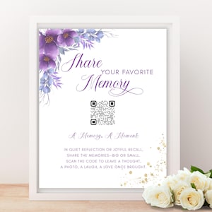 May include: A framed white sign with purple floral accents and the words "Share Your Favorite Memory." Includes a QR code and text encouraging sharing memories. Gold glitter accents and white roses are visible.