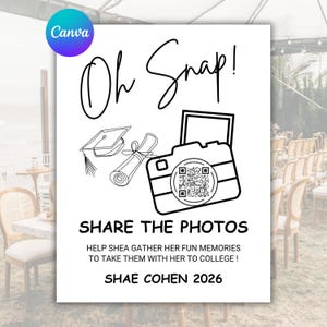 May include: White sign with black text and line drawings. The sign says "Oh Snap!" and "Share the Photos." A camera graphic with a QR code is featured. The sign is for Shea Cohen's graduation in 2026.