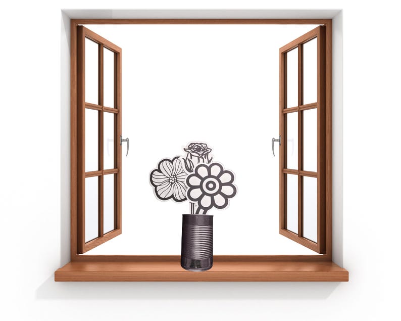 May include: A dark gray metal tin can serving as a vase, containing three distinct black and white line-art flower cutouts. The flowers feature varied petal shapes, including a rose-like bloom, a daisy-like flower, and a circular patterned blossom.