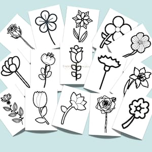 May include: A collection of rectangular white cards featuring black line art illustrations of various flowers. Each card displays a unique botanical drawing, including roses, tulips, and daisies, arranged in a scattered, overlapping layout.