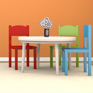 May include: A white round table with four tapered legs, accompanied by three wooden chairs in red, lime green, and blue. A small dark vase sits in the center of the table, holding a bouquet of three black and white line-art flower cutouts.