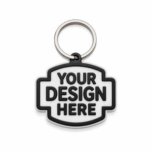 May include: A white and black keychain with the text "YOUR DESIGN HERE". The keychain has a silver key ring and a black border. The design is a custom, personalized item.