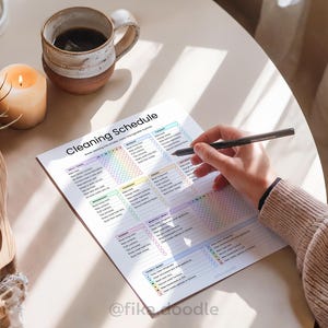Lifestyle mockup of an ADHD cleaning planner printable PDF being used at home with a cozy morning setup, featuring a customizable cleaning schedule, daily cleaning routine tracker, and ADHD-friendly home organization system designed to reduce overwhelm and simplify household cleaning routines. Printable and digital cleaning planner editable in Canva.