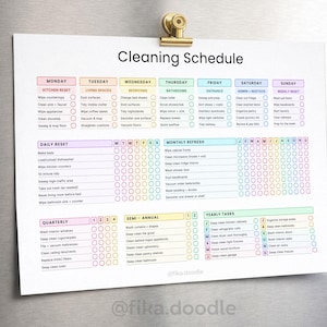 ADHD cleaning schedule printable PDF displayed on a refrigerator with daily, weekly, monthly, quarterly, and yearly cleaning routines designed to simplify home cleaning and reduce overwhelm. Includes ADHD-friendly cleaning checklists, reset routines, and step-by-step household management systems for consistent cleaning habits and home organization.
