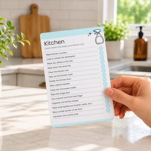 Printable kitchen cleaning card featuring a room-by-room cleaning checklist designed to simplify household chores. ADHD-friendly cleaning card helps break cleaning into manageable tasks and can be customized in Canva, printed at home, laminated, and reused as part of a home organization system.