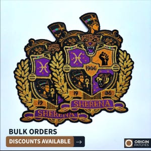 May include: Embroidered patches with a purple, gold, and black design. The patches feature a crest with a tiger, Egyptian figures, and the word "Sherena". The patches have the text "1996" and "19" and are surrounded by a gold laurel wreath.