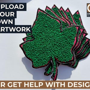 May include: A stack of green leaf-shaped embroidered patches with pink and black trim. The patches are on a white surface. Text on the image reads "UPLOAD YOUR OWN ARTWORK" and "OR GET HELP WITH DESIGN". The Origin Patches logo is in the upper right corner.