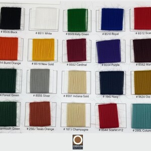 May include: Color chart featuring swatches of various thread colors, including black, white, green, blue, and red. Each swatch is labeled with a color name and a corresponding code number. The chart includes shades of orange, gold, purple, maroon, and more.