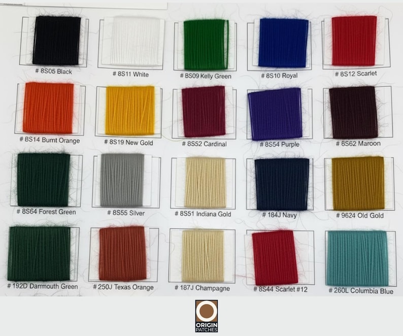 May include: Color chart featuring swatches of various thread colors, including black, white, green, blue, and red. Each swatch is labeled with a color name and a corresponding code number. The chart includes shades of orange, gold, purple, maroon, and more.