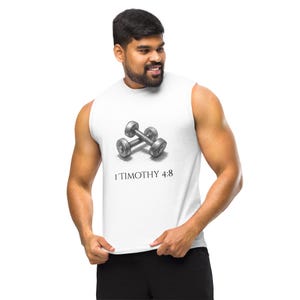 May include: White sleeveless top featuring a pencil-drawn image of two dumbbells and the text "1 Timothy 4:8". The top is made of a soft, comfortable material, suitable for workouts or casual wear.