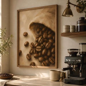 May include: A framed wall art print featuring an oil painting of a burlap sack spilling dark roasted coffee beans onto a light beige surface. The artwork is rendered in warm brown and cream tones with visible brushstrokes, displayed in a wooden frame.
