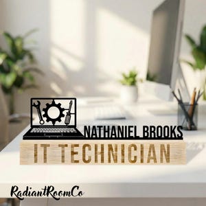 May include: A wooden desk nameplate with the name "NATHANIEL BROOKS" and the title "IT TECHNICIAN" engraved in a light brown colour. A black laptop silhouette with tools is on the left. The RadiantRoomCo logo is at the bottom.