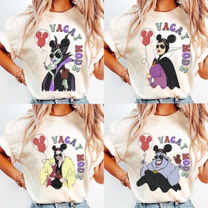May include: Four cream-colored t-shirts with the phrase "Vacay Mode" and cartoon illustrations of Disney villains. Each shirt features a different villain holding a balloon and a snack, with a Mickey Mouse ear design.