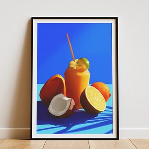 May include: A framed art print featuring a vibrant still life. An orange smoothie with a straw and lime garnish sits next to a halved orange, a whole orange, a coconut, and a papaya against a blue background.