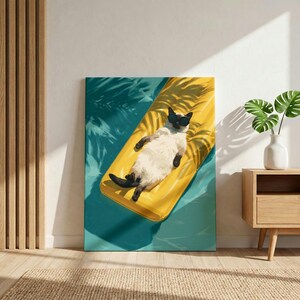 May include: A rectangular wall art print featuring a Siamese cat wearing black sunglasses, lying on a bright yellow inflatable pool float. The cat is positioned in the center of the image, surrounded by turquoise blue water with palm leaf shadows.
