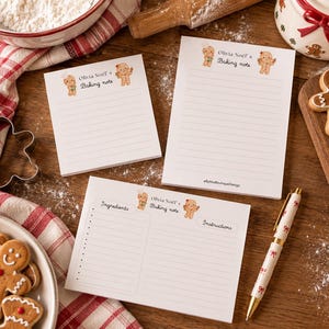 May include: Three white paper notepads with lined pages and gingerbread person illustrations. The text reads Olivia Noel's Baking note, Ingredients, and Instructions. One notepad is square, one is rectangular, and one is a recipe card format.