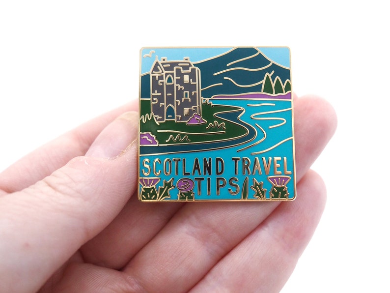 Scotland Travel Tips enamel pin. image 1