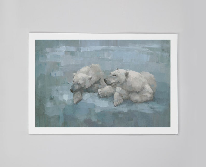 May include: A framed art print featuring two polar bears in a serene, painterly style. The bears, rendered in shades of white and gray, are depicted resting against a backdrop of cool blue tones. The artwork is presented in a white frame.