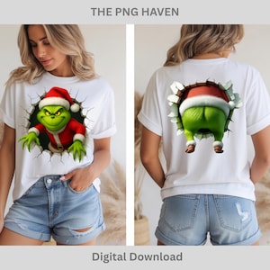 Peut inclure: T-shirts blancs avec un motif du Grinch. Le devant du t-shirt présente le Grinch avec un chapeau de Père Noël et un costume rouge sortant d'un trou. Le dos du t-shirt montre le derrière du Grinch. Le texte en haut indique "THE PNG HAVEN" et en bas "Digital Download".