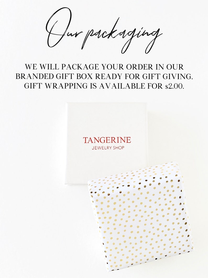 May include: White gift box with the text "TANGERINE JEWELRY SHOP" in red. A second gift box is wrapped in white paper with gold polka dots. The text "Our packaging" is written in cursive.