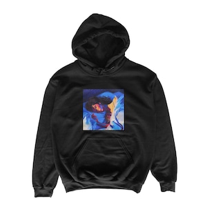 May include: Black hooded sweatshirt with a front pocket and a drawstring hood. The sweatshirt features a square graphic of a person in bed, with blue and yellow tones. The graphic is centered on the chest.