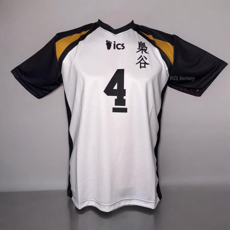 May include: White and black volleyball jersey with the number 4 in black on the front. The jersey has black sleeves and gold accents on the shoulders. The text "ics" and Japanese characters are printed on the front. The text "KQ Jersey" is printed on the sleeve.