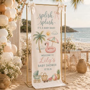 May include: A vertical fabric banner on a gold metal stand featuring the text splish splash IT'S A BABY BASH! WELCOME TO Lily's BABY SHOWER 07.18.26. The design includes a palm tree, a pink flamingo float, a beach umbrella, a stroller, and fruit.