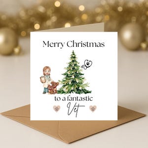 May include: A Christmas card featuring a vet, two dogs, and a Christmas tree illustration. The card says "Merry Christmas to a fantastic Vet" with paw prints. The card is placed on a brown envelope, with festive decorations in the background.