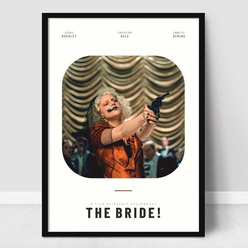 May include: A framed movie poster featuring a woman in a red dress holding a gun, with the title "THE BRIDE!" below. The poster includes the names Jessie Buckley, Christian Bale, and Annette Bening.