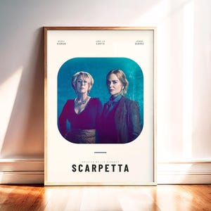 May include: Framed poster featuring two women in a teal and purple background. The poster has the title "SCARPETTA" in white text. The names "Nicole Kidman", "Jamie Lee Curtis", and "Annabeth Gish" are listed at the top.