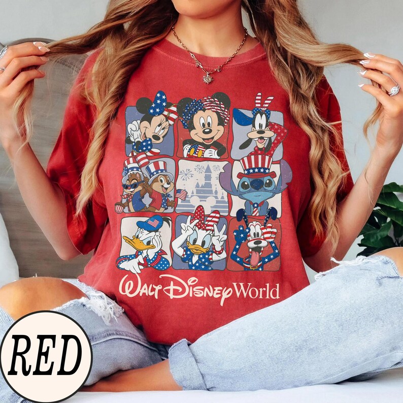May include: Red t-shirt featuring a grid of Disney characters in patriotic attire. Mickey and Minnie Mouse, Donald and Daisy Duck, Goofy, Chip and Dale, and Stitch are depicted. The text "Walt Disney World" is printed below the grid.