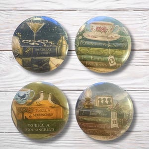 May include: Four circular pin badges with literary designs. The badges depict a cocktail glass over "The Great Gatsby", a teacup over "Pride and Prejudice", birds over "To Kill a Mockingbird", and a lamp over "Jane Eyre".