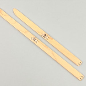 May include: Two wooden knitting needles with the text "Stephen Hillel" written on them.