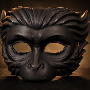 May include: A dark brown, sculpted monkey mask featuring detailed fur textures, prominent brow ridges, almond-shaped eye openings, and a defined snout. The mask has a symmetrical design with sweeping hair patterns extending outward from the center.