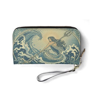 May include: A rectangular wallet with a zipper closure and wrist strap. The wallet features an illustration of a woman with long hair holding a trident, set against a backdrop of ocean waves and a sunburst. The color palette includes shades of blue, beige, and gold.