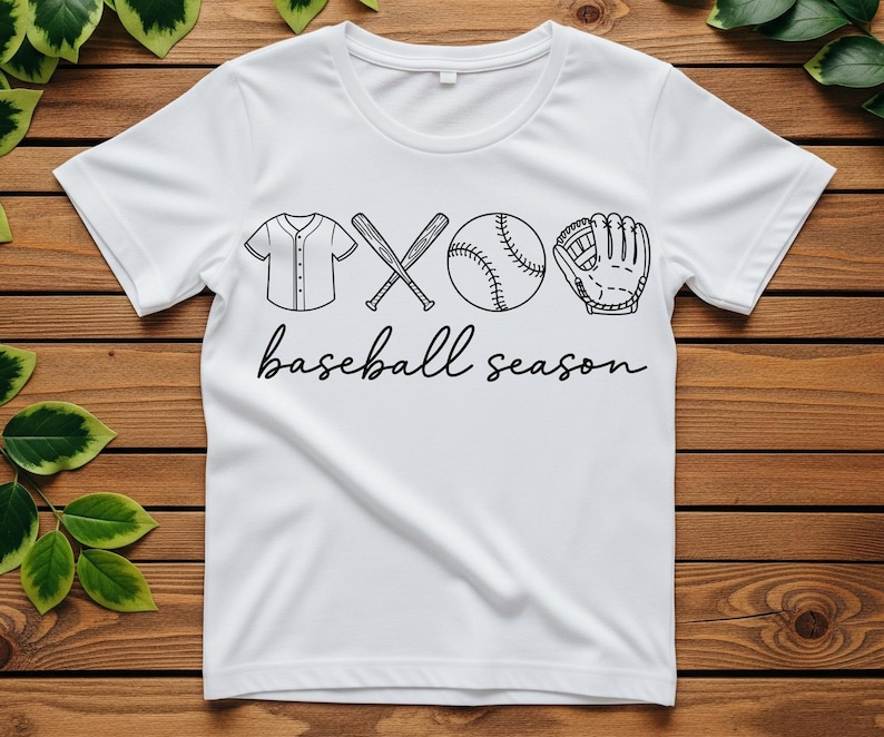 May include: White t-shirt with a black graphic of baseball equipment, including a jersey, crossed bats, a baseball, and a glove. The words "baseball season" are written in a cursive font below the graphic.