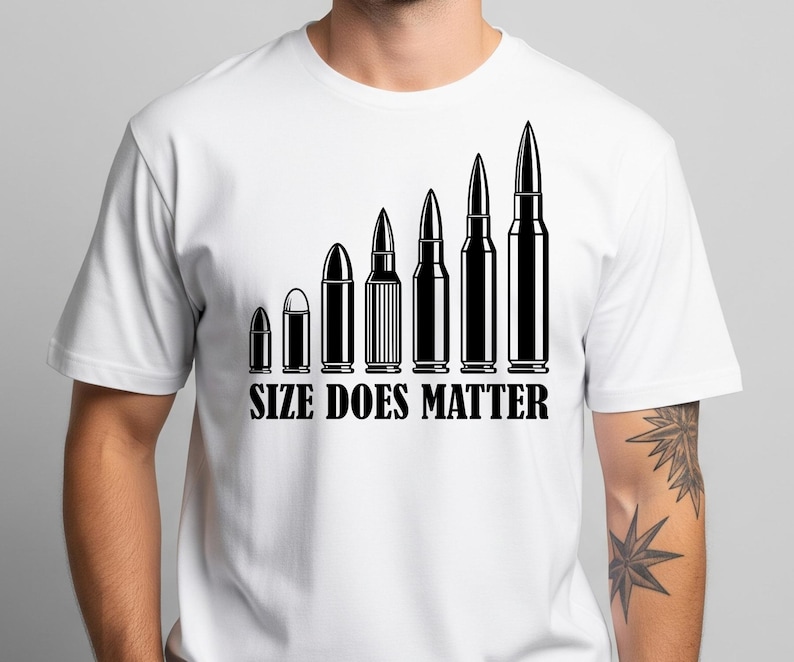 May include: White t-shirt featuring a black graphic of bullets increasing in size. The phrase "SIZE DOES MATTER" is printed beneath the bullets in a bold font. The t-shirt has a crew neck design and is made of a light fabric.