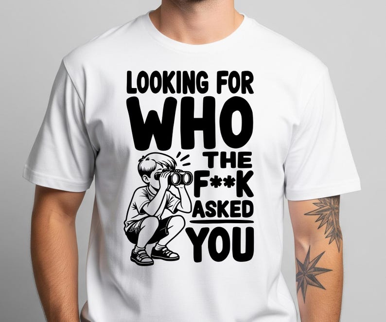 May include: White t-shirt with a black graphic. The graphic features the text "LOOKING FOR WHO THE F*** ASKED YOU" and an illustration of a child looking through binoculars. The shirt is a crew neck.